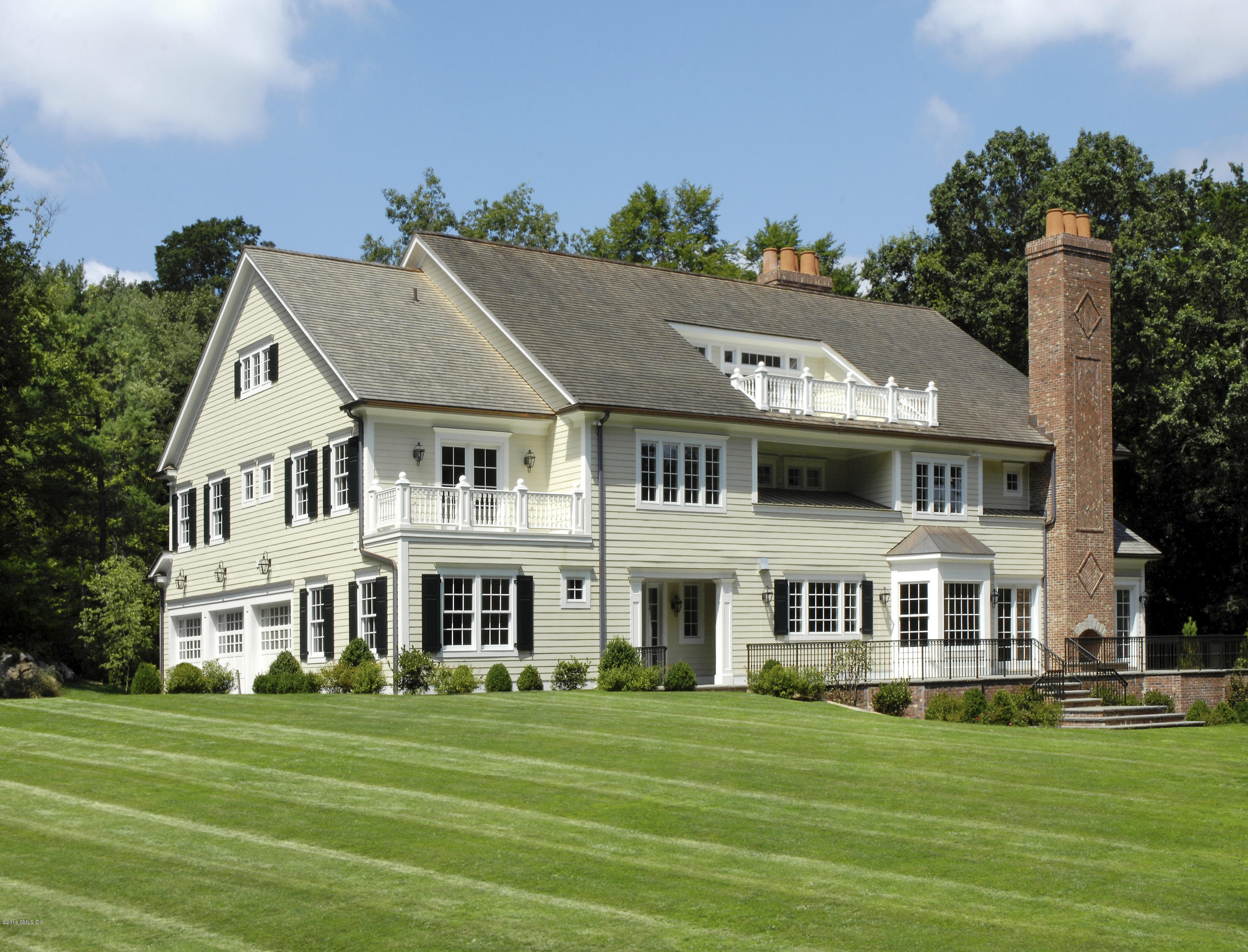 43 Burning Tree Road Greenwich, CT 06830 - Photo 17 of 24 a view of a white house with a big yard and potted plants