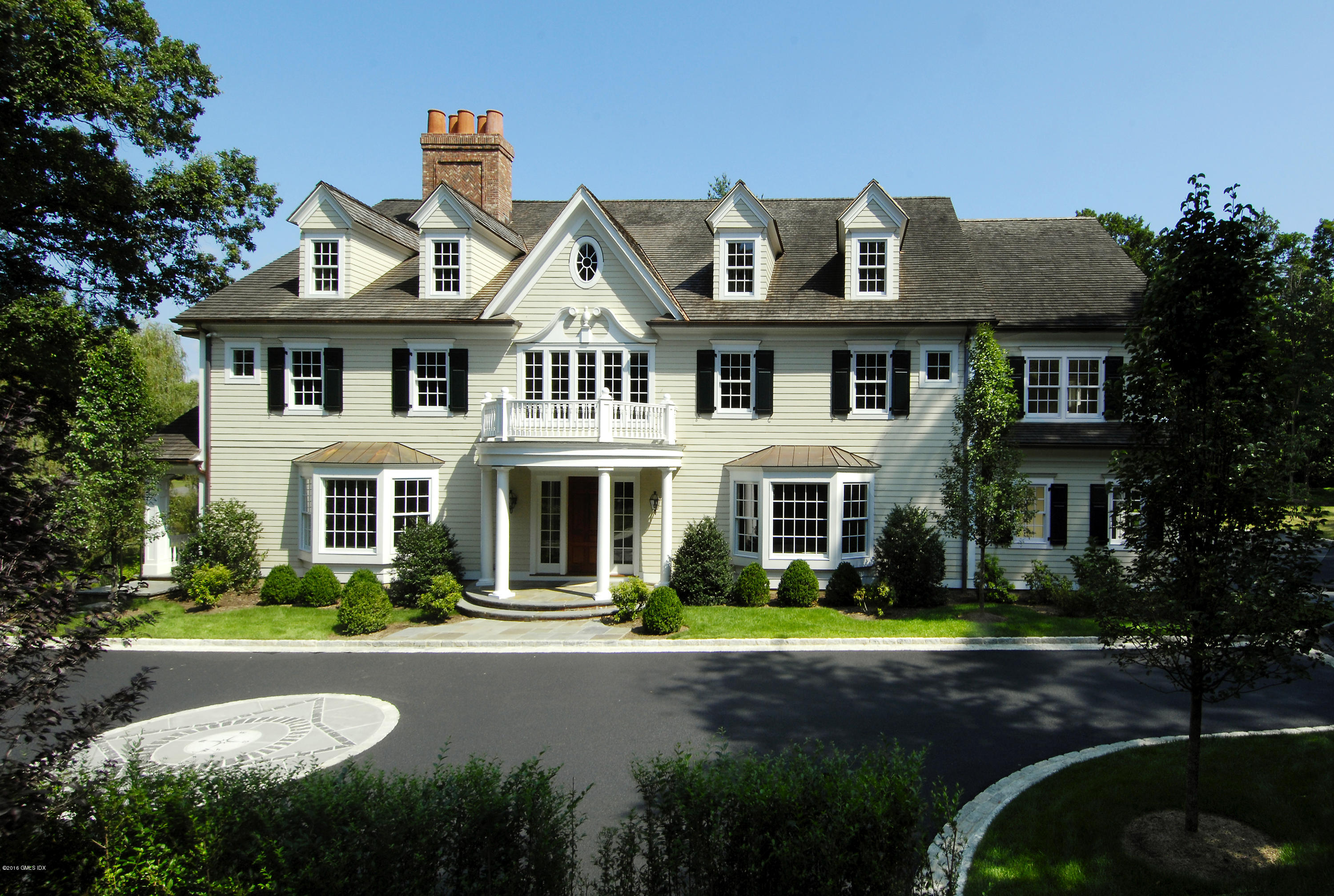 43 Burning Tree Road Greenwich, CT 06830 - Photo 2 of 24 a front view of a house with garden and trees