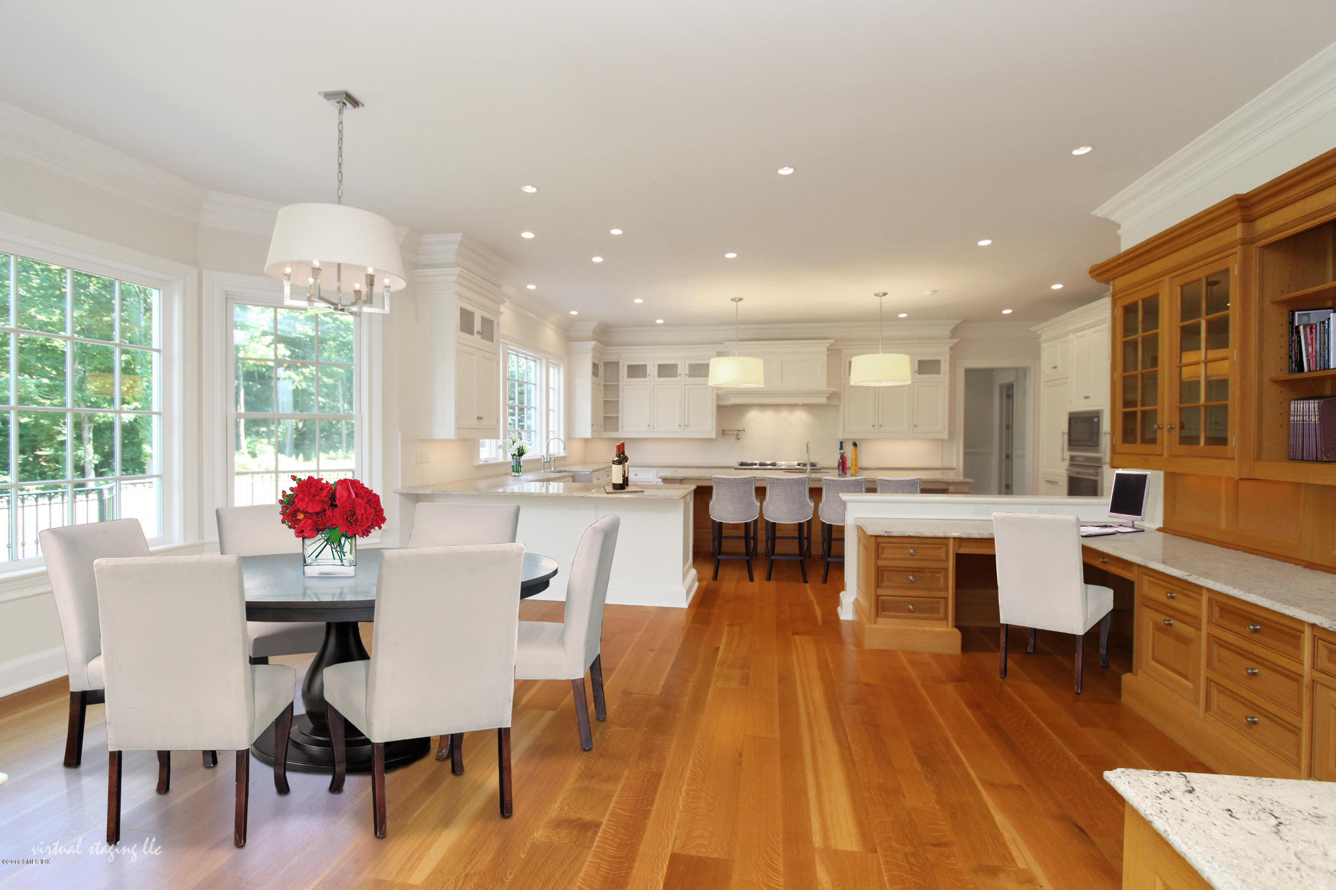 43 Burning Tree Road Greenwich, CT 06830 - Photo 10 of 24 a view of a dining room and livingroom with furniture wooden floor a chandelier