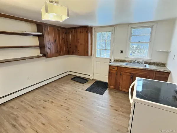 a kitchen with a cabinets and wooden floor