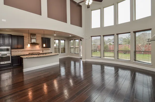 a kitchen with stainless steel appliances granite countertop a stove and cabinets with wooden floor