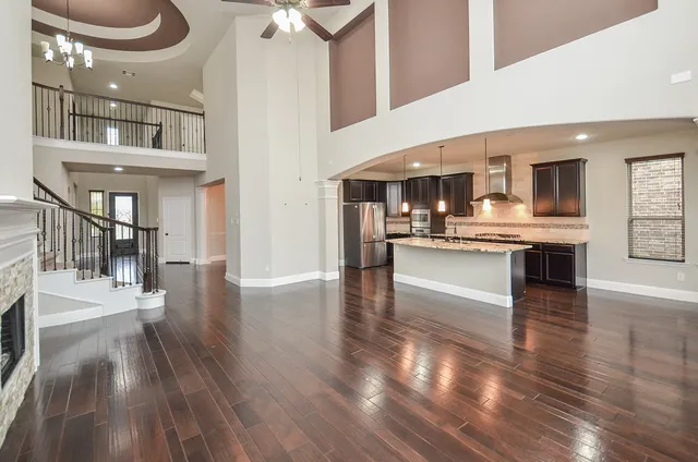 a kitchen with stainless steel appliances granite countertop a stove and cabinets with wooden floor