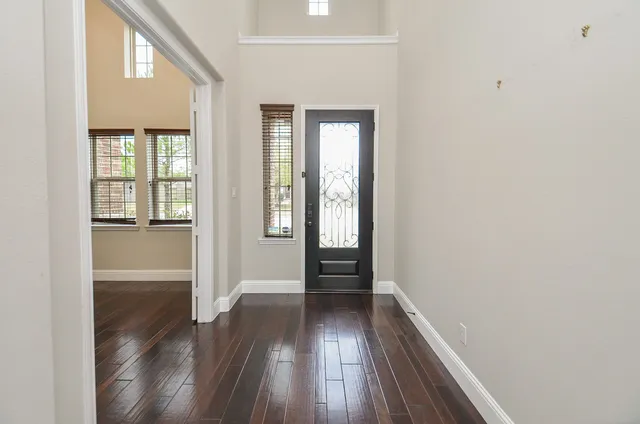 wooden floor in an empty room with a window
