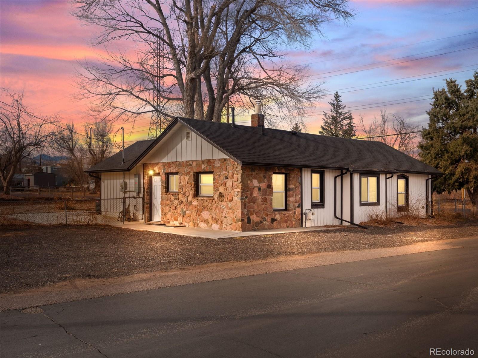 16130 Mt Vernon Road Golden, CO 80401 - Photo 4 of 22 a front view of a house with a yard