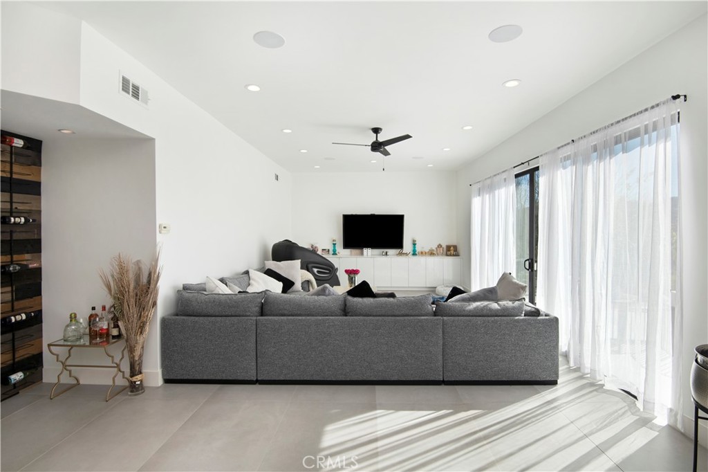 22254 Dumetz Road Woodland Hills, CA 91364 - Photo 13 of 42 a living room with furniture and a flat screen tv