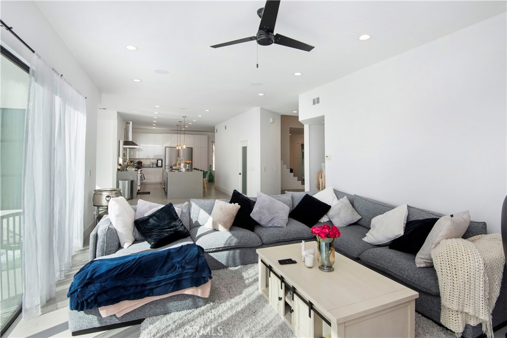 22254 Dumetz Road Woodland Hills, CA 91364 - Photo 16 of 42 a living room with furniture and a chandelier