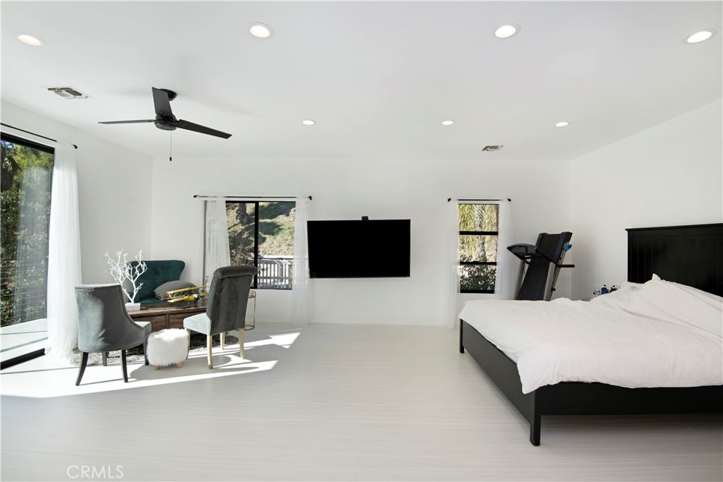 22254 Dumetz Road Woodland Hills, CA 91364 - Photo 25 of 42 a living room with furniture and a flat screen tv