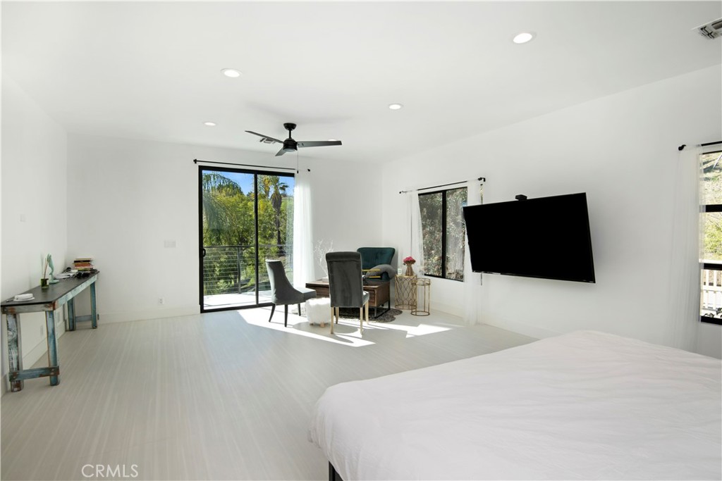 22254 Dumetz Road Woodland Hills, CA 91364 - Photo 26 of 42 a room with a bed and a flat screen tv