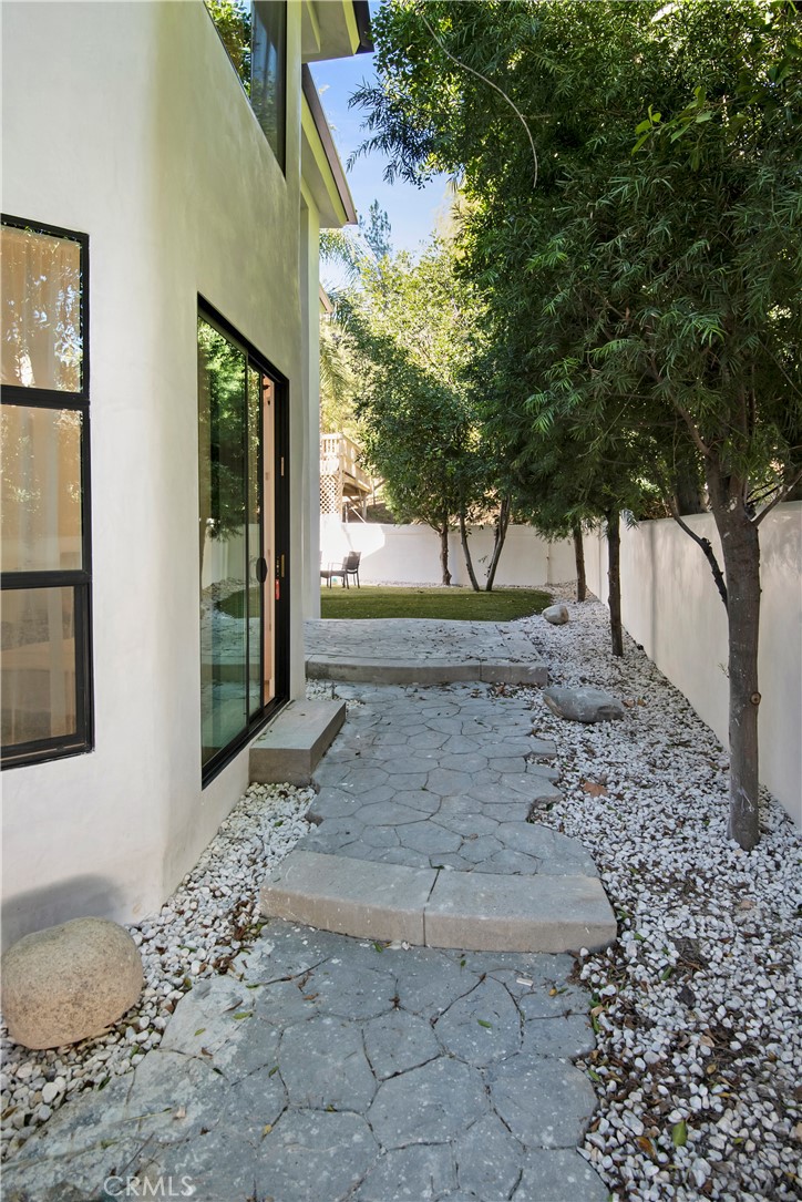 22254 Dumetz Road Woodland Hills, CA 91364 - Photo 3 of 42 a view of a backyard with large trees