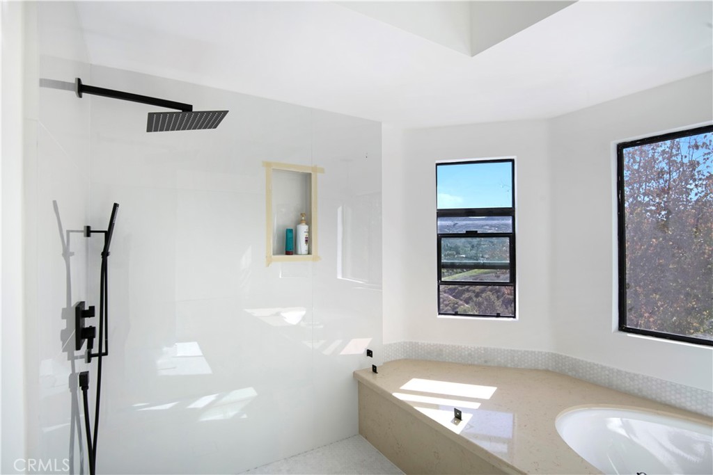 22254 Dumetz Road Woodland Hills, CA 91364 - Photo 31 of 42 a bathroom with a bathtub and a shower