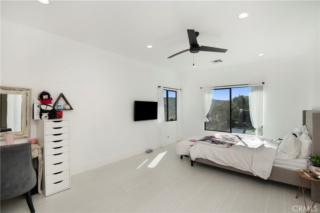 22254 Dumetz Road Woodland Hills, CA 91364 - Photo 32 of 42 a bedroom with furniture and a flat screen tv