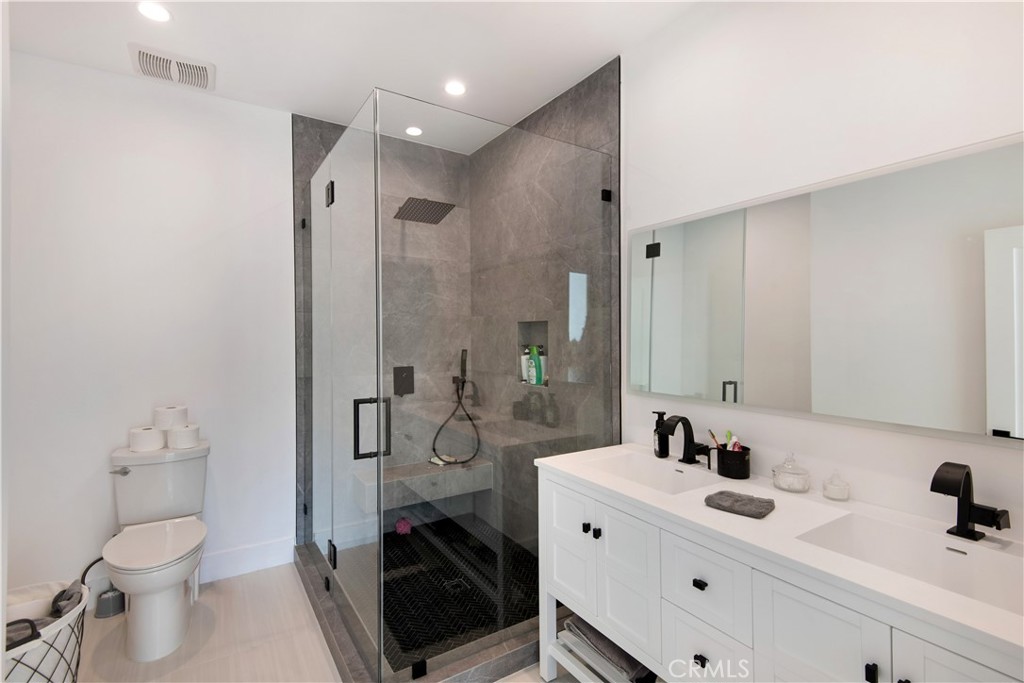 22254 Dumetz Road Woodland Hills, CA 91364 - Photo 33 of 42 a bathroom with a sink toilet and shower