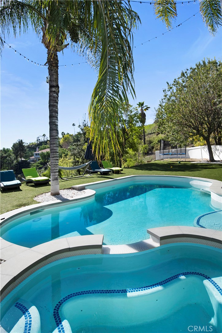 22254 Dumetz Road Woodland Hills, CA 91364 - Photo 38 of 42 a view of a swimming pool with a yard