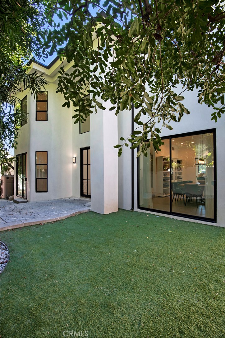 22254 Dumetz Road Woodland Hills, CA 91364 - Photo 5 of 42 a view of a house with a yard and a tree