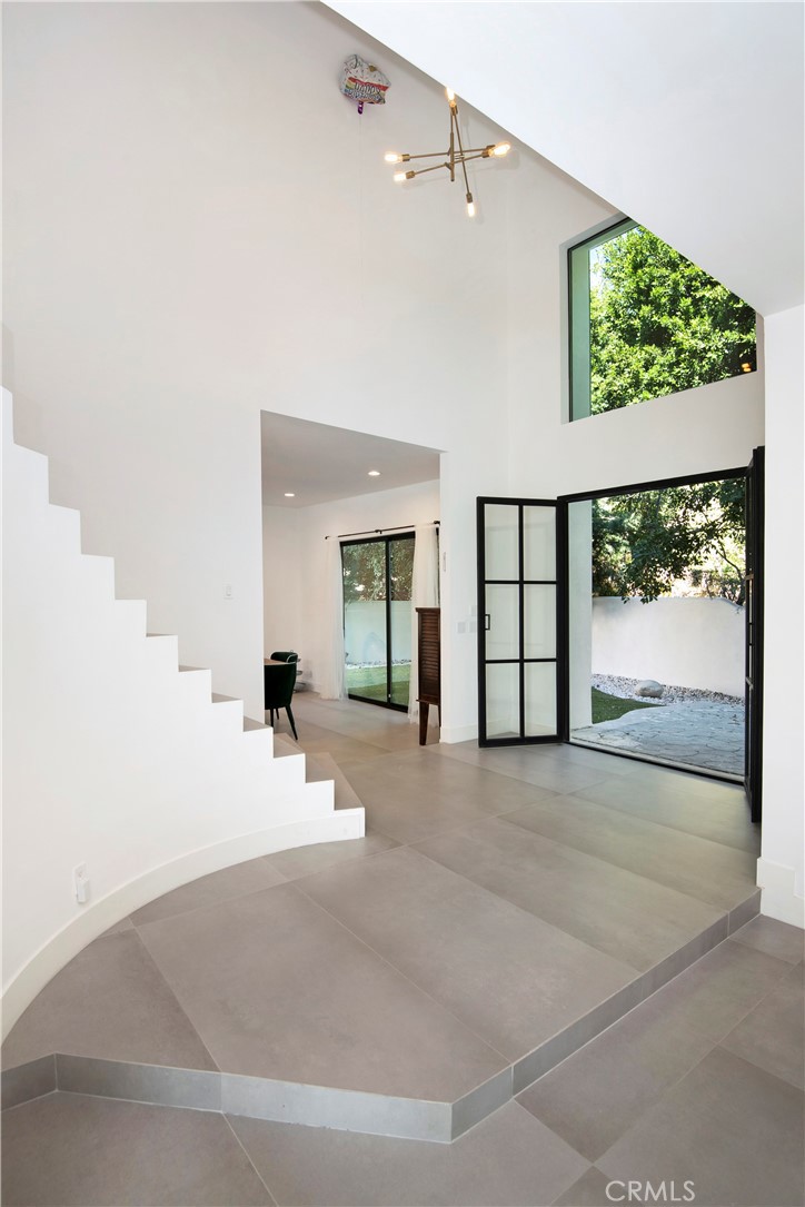 22254 Dumetz Road Woodland Hills, CA 91364 - Photo 8 of 42 a view of a big room with windows and entryway