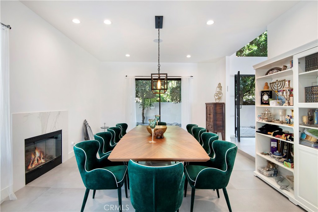 22254 Dumetz Road Woodland Hills, CA 91364 - Photo 10 of 42 a dining room with furniture a rug and a chandelier