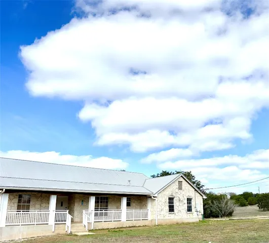 a view of house with swimming pool