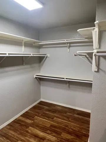 a view of a room with wooden floor