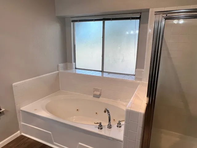 a bathroom with a bathtub and a shower