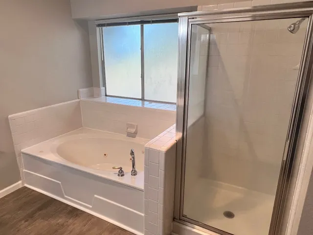 a bathroom with a bathtub and a shower