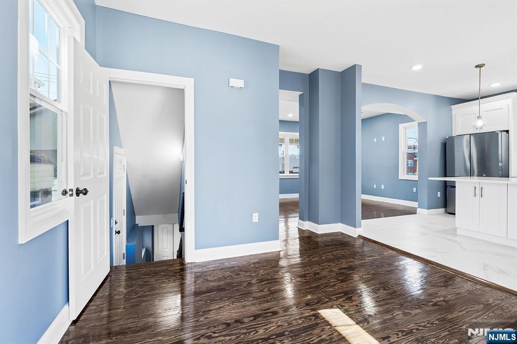 255 Garibaldi Avenue Lodi, NJ 07644 - Photo 13 of 34 a view of a hallway with wooden floor table and chairs
