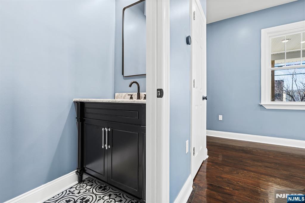 255 Garibaldi Avenue Lodi, NJ 07644 - Photo 14 of 34 a view of a hallway with wooden floor and a bathroom