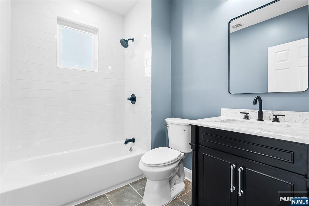 255 Garibaldi Avenue Lodi, NJ 07644 - Photo 18 of 34 a bathroom with a sink a toilet and a bathtub