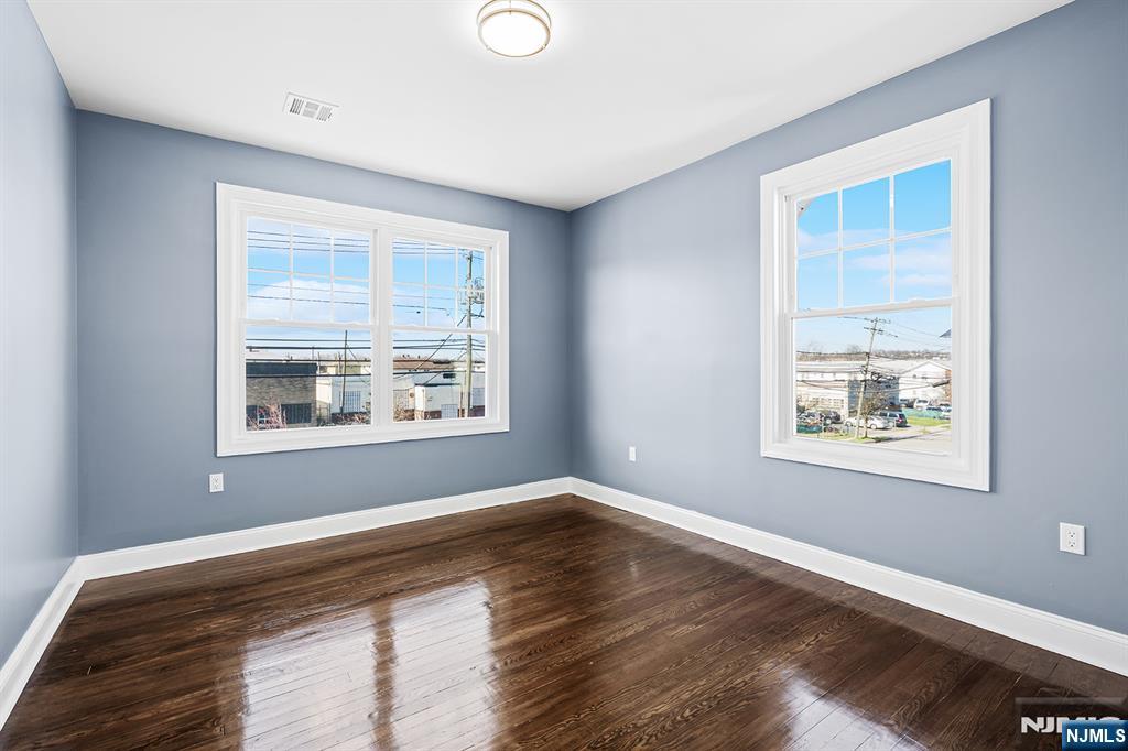 255 Garibaldi Avenue Lodi, NJ 07644 - Photo 19 of 34 a view of an empty room with wooden floor and a window