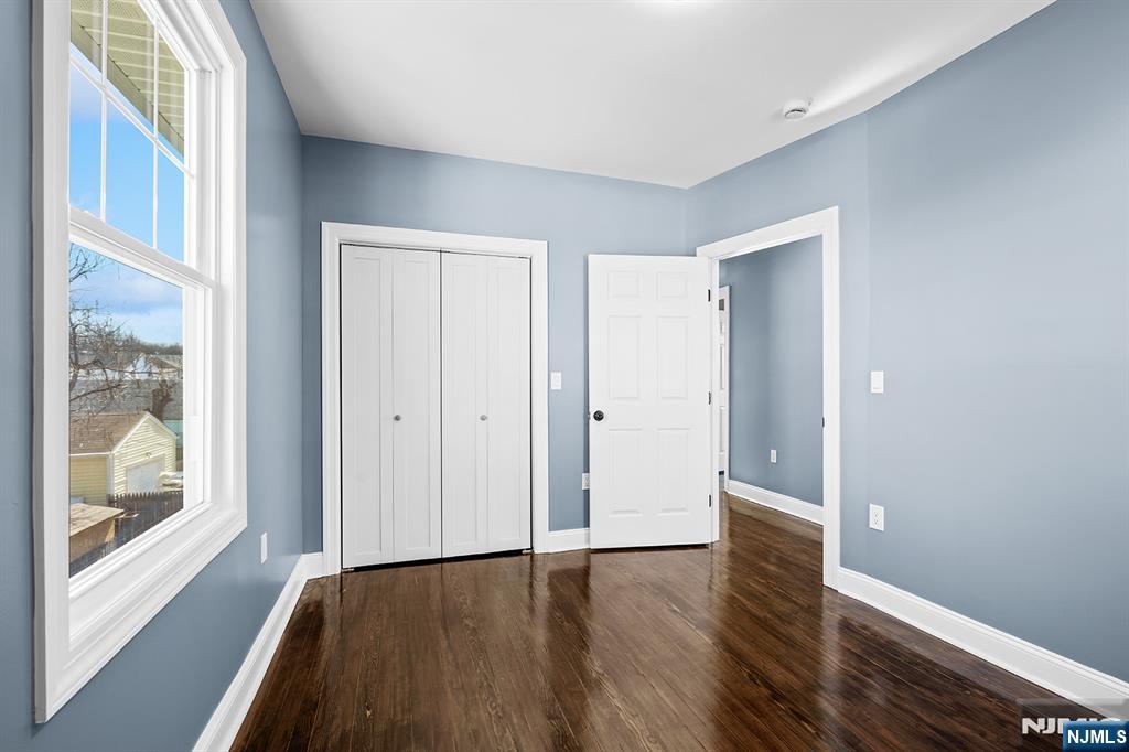 255 Garibaldi Avenue Lodi, NJ 07644 - Photo 20 of 34 a view of an empty room with wooden floor and a window