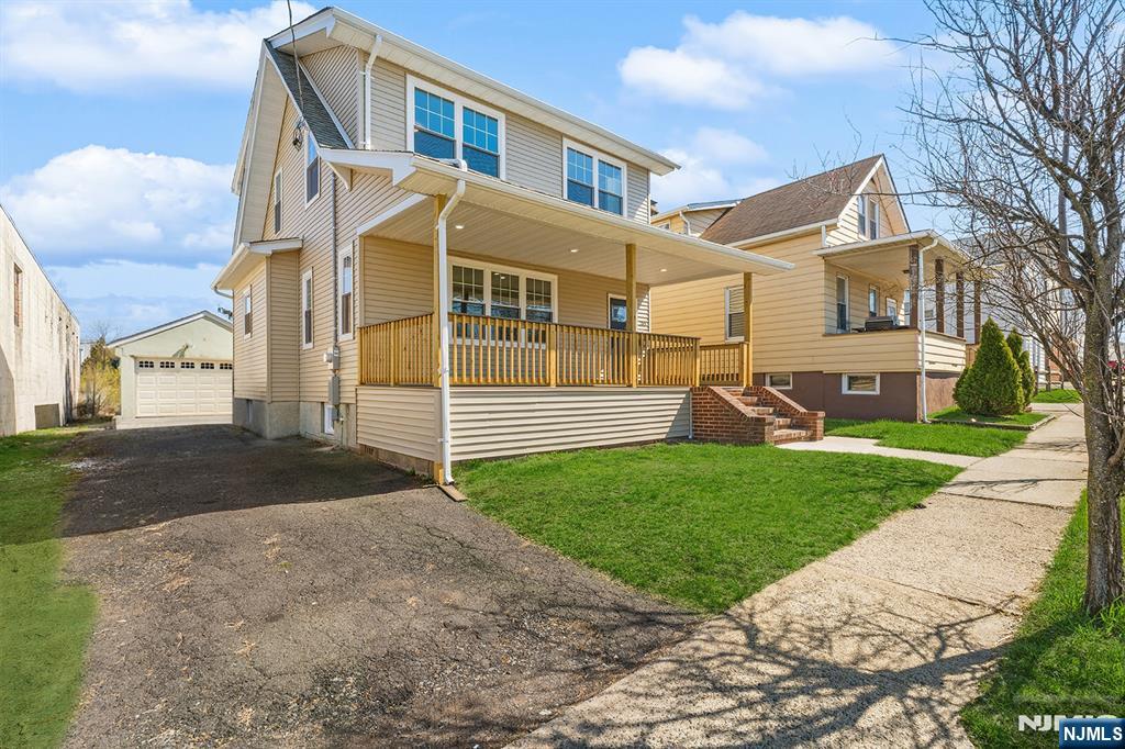 255 Garibaldi Avenue Lodi, NJ 07644 - Photo 2 of 34 a view of a house with a yard and street