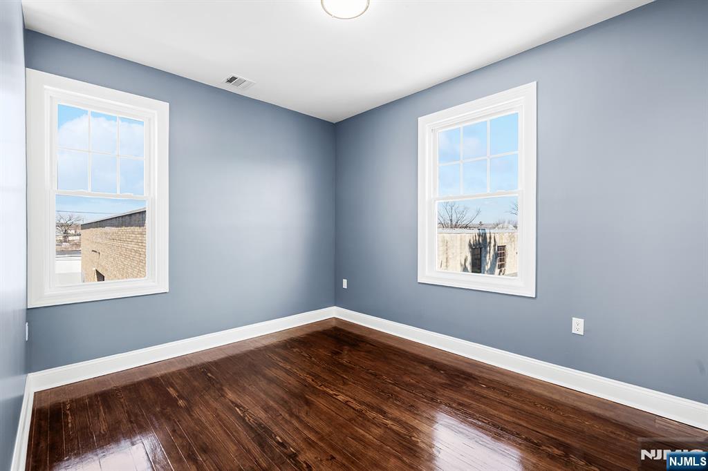 255 Garibaldi Avenue Lodi, NJ 07644 - Photo 22 of 34 a view of an empty room with wooden floor and a window
