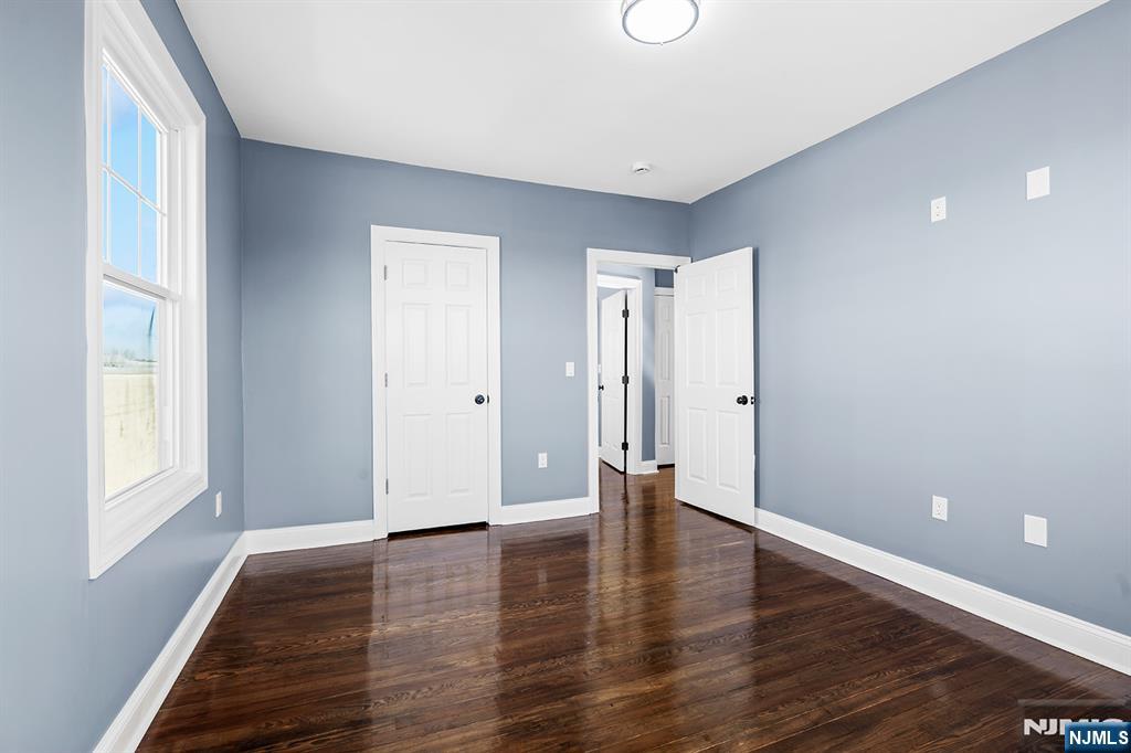 255 Garibaldi Avenue Lodi, NJ 07644 - Photo 23 of 34 a view of an empty room with window and wooden floor