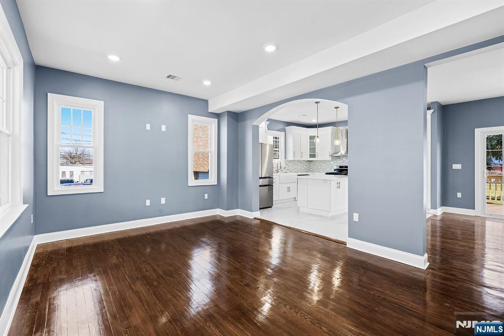 255 Garibaldi Avenue Lodi, NJ 07644 - Photo 5 of 34 a view of a big room with wooden floor and windows