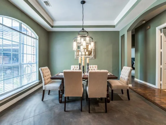 a dining room with furniture a chandelier and wooden floor