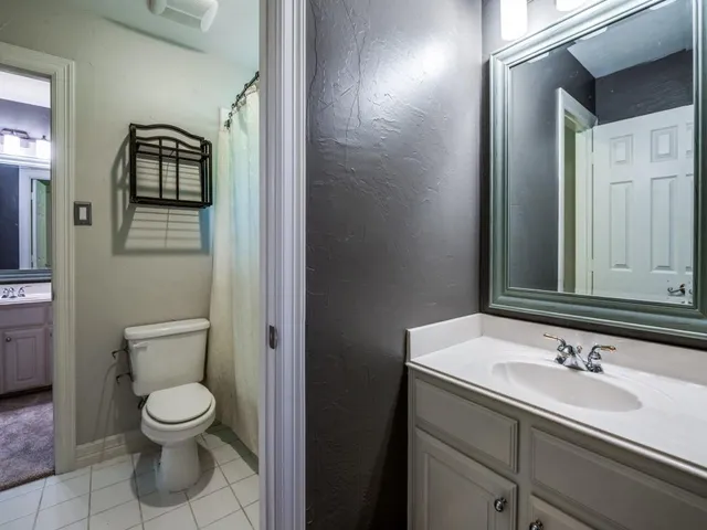 a bathroom with a toilet sink shower and mirror