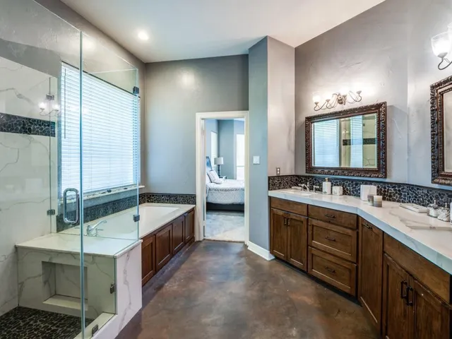 a bathroom with double vanity sinks and a bathtub