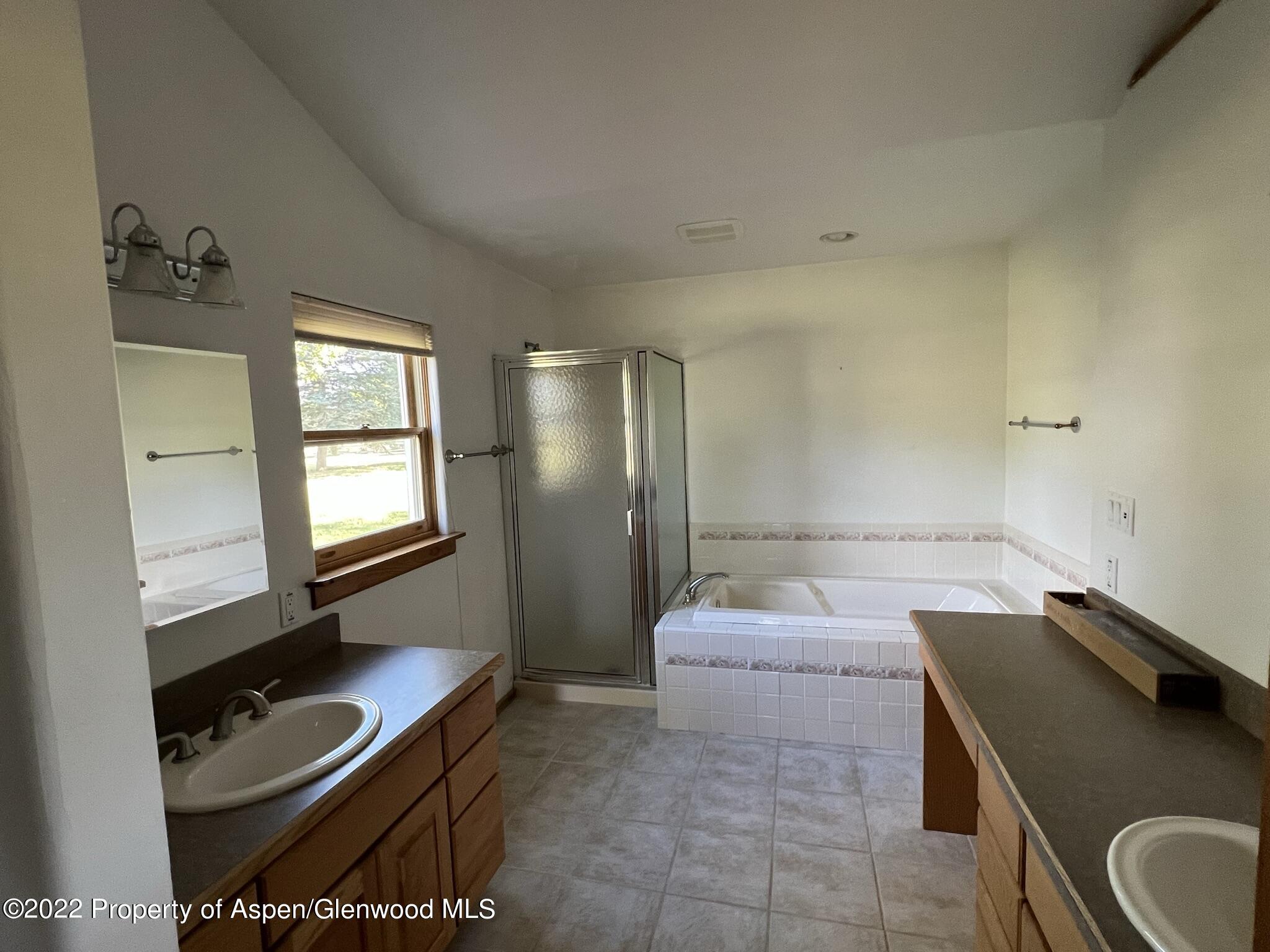 248 Fox Run Road Rifle, CO 81650 - Photo 7 of 14 a bathroom with a granite countertop sink a toilet and bathtub
