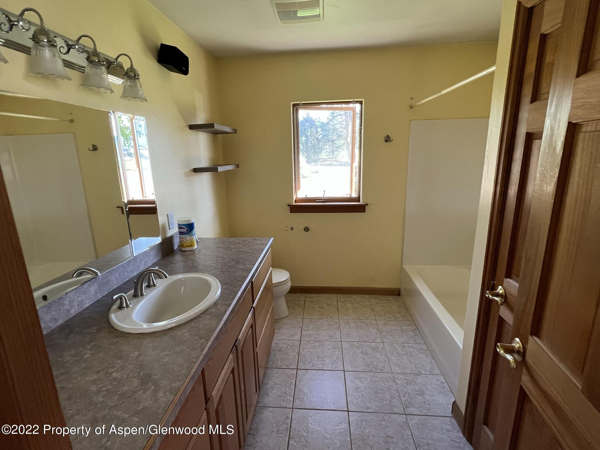 248 Fox Run Road Rifle, CO 81650 - Photo 8 of 14 a bathroom with a sink double vanity and a mirror