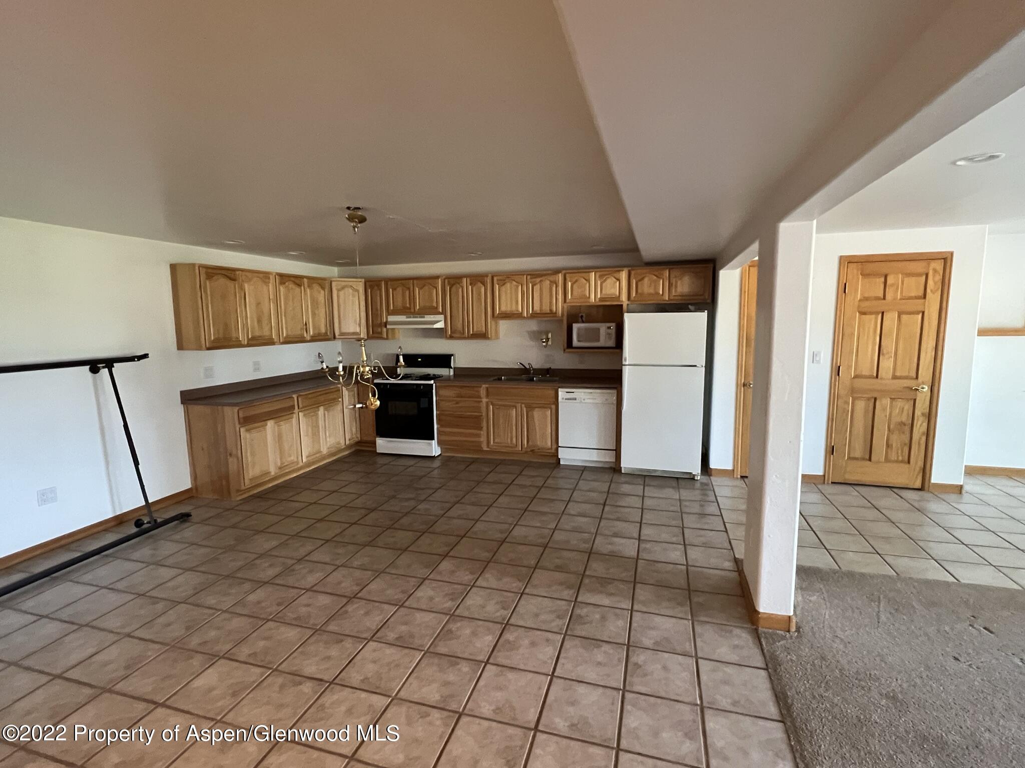 248 Fox Run Road Rifle, CO 81650 - Photo 10 of 14 a kitchen with stainless steel appliances a refrigerator sink and cabinets