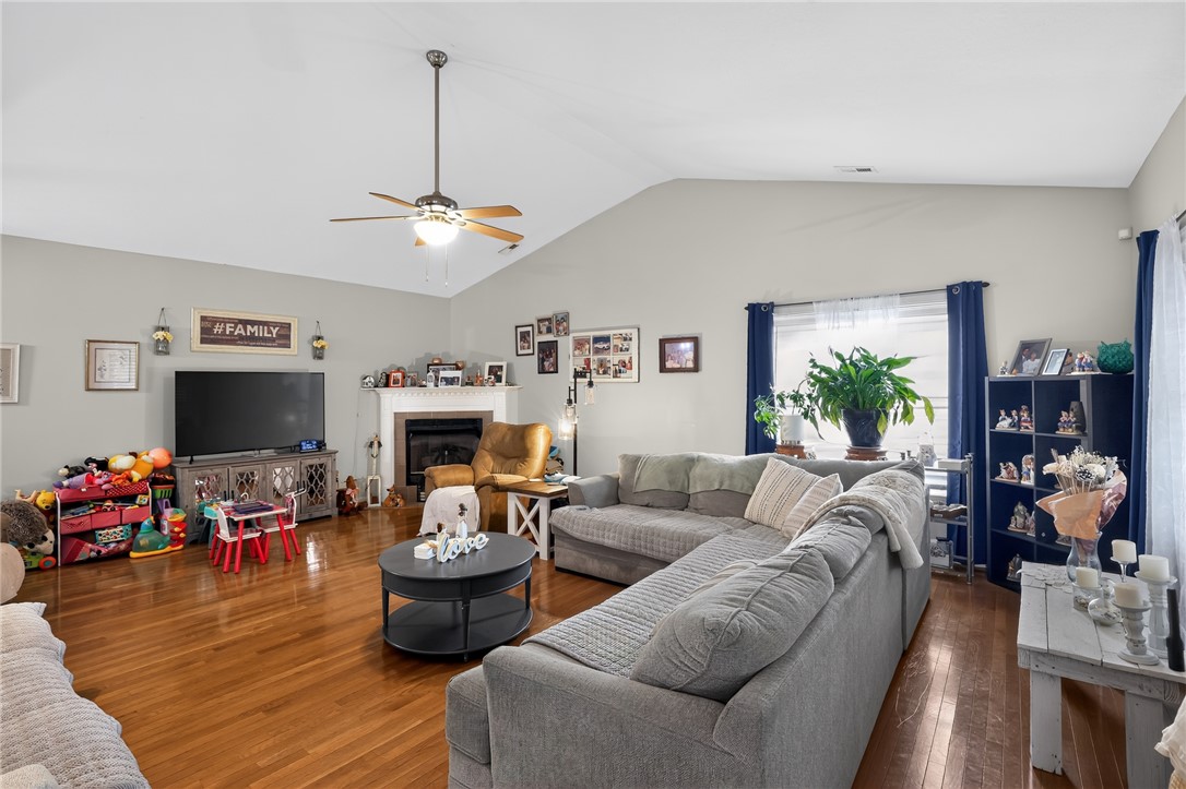 144 Elliott Circle Anderson, SC 29621 - Photo 6 of 30 Hardwood floors and a cozy fireplace anchor this inviting living space.