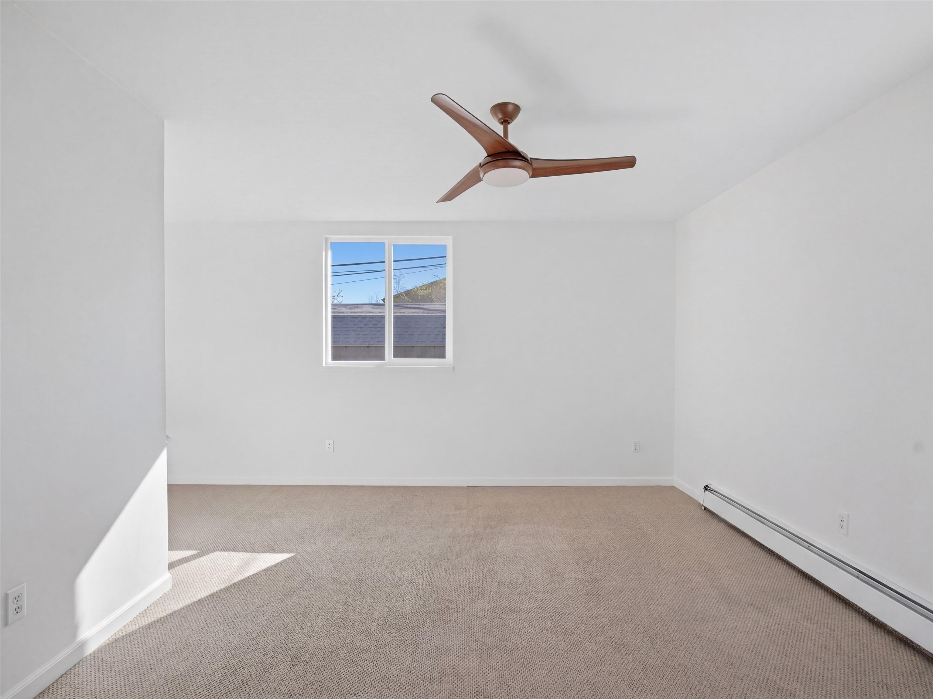 252 South Peach Street Fruita, CO 81521 - Photo 12 of 22 an empty room with a ceiling fan and window