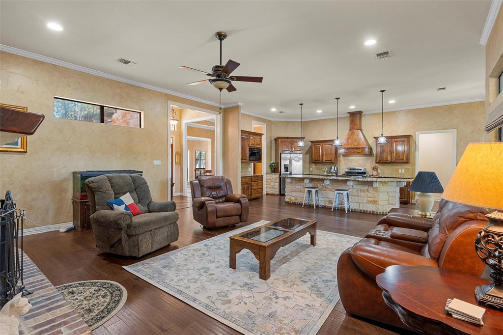 1125 Whispering Oaks China Spring, TX 76633 - Photo 11 of 39 Living room with crown molding, ceiling fan, dark wood-type flooring, and recessed lighting