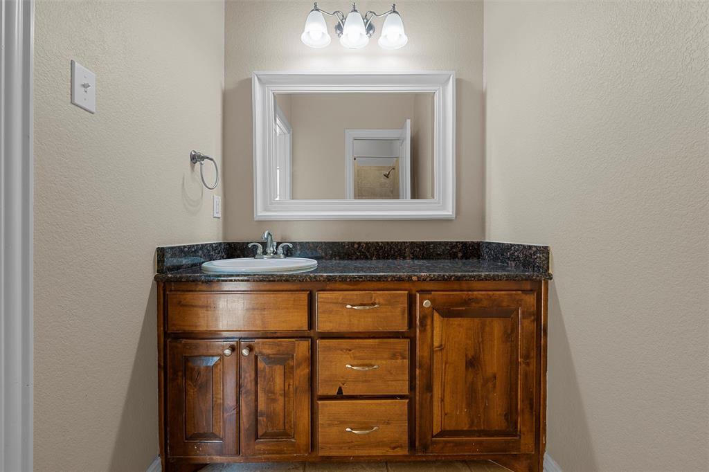 1125 Whispering Oaks China Spring, TX 76633 - Photo 24 of 39 Bathroom featuring a textured wall and vanity