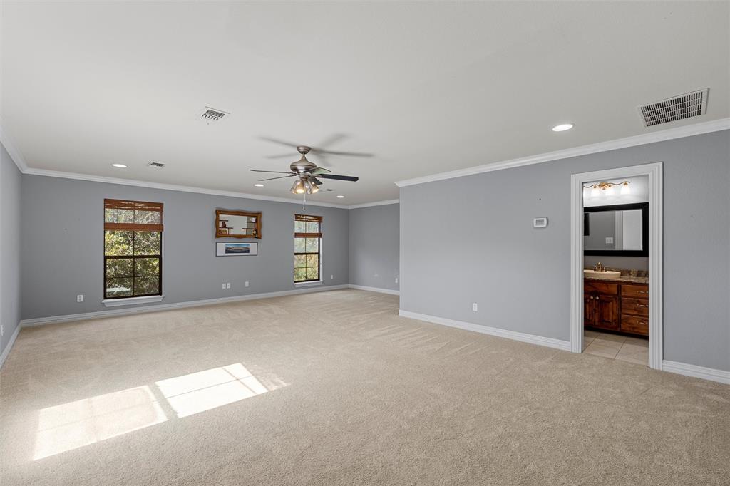 1125 Whispering Oaks China Spring, TX 76633 - Photo 26 of 39 Unfurnished room with ornamental molding, recessed lighting, light carpet, and ceiling fan