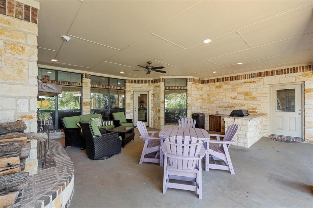 1125 Whispering Oaks China Spring, TX 76633 - Photo 30 of 39 View of patio with ceiling fan, exterior kitchen, outdoor dining space, and an outdoor hangout area