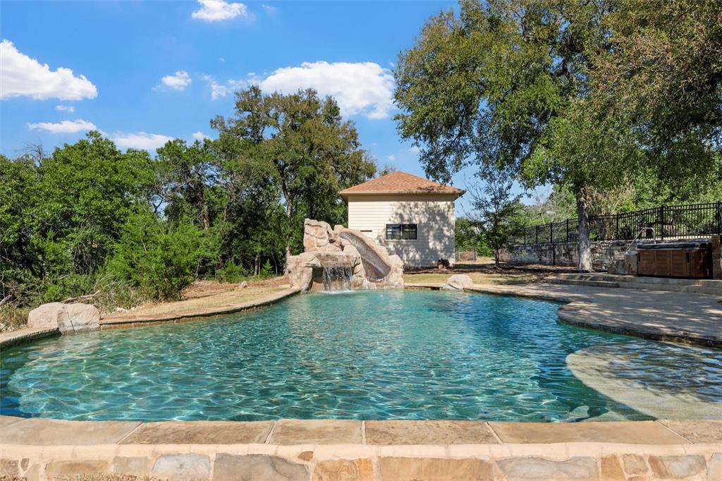 1125 Whispering Oaks China Spring, TX 76633 - Photo 34 of 39 View of pool featuring a water slide, an outdoor structure, and a patio