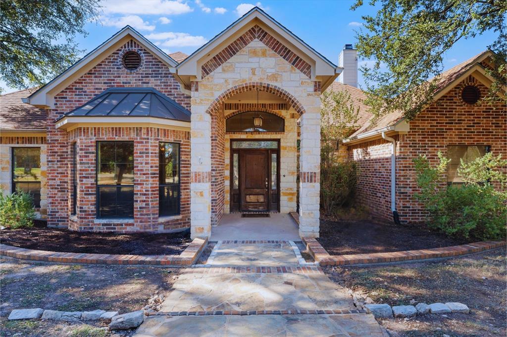 1125 Whispering Oaks China Spring, TX 76633 - Photo 4 of 39 Property entrance featuring brick siding, a chimney, and stone siding