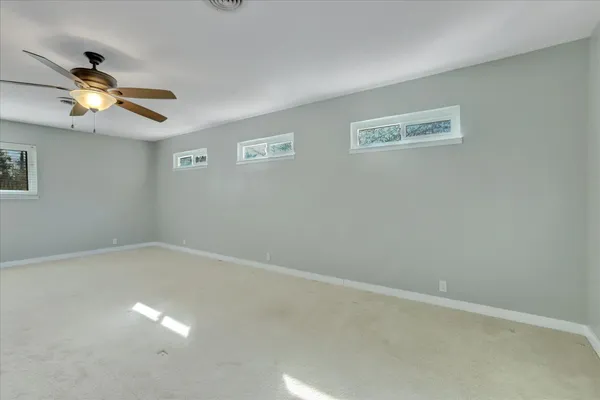 a bathroom with a toilet sink vanity and mirror
