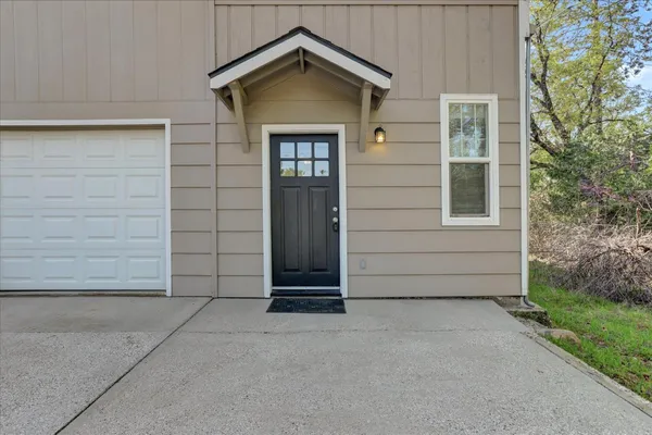 a view of a patio with table and chairs and potted plants