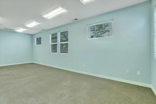 a view of a house with backyard and a patio